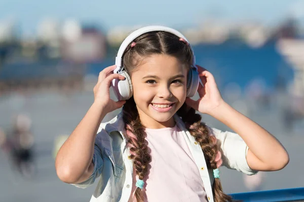 Exciting journeys through cities and museums. Audio tour headphones gadget. City guide and audio tour. Girl little tourist kid explore city using audio guide application. Free style of travelling
