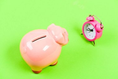 Financial crisis. Economics and finance. Banking account. Bankruptcy and debt. Pay for debt. Bank collector service. Credit debt. It is time to pay. Piggy bank pink pig and little alarm clock clipart