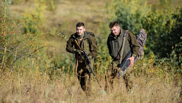 Stroper partner in criminaliteit. Activiteit voor echte mannen concept. Jagers jachtopzieners op zoek naar dier of vogel. Illegale jacht. Jagers vrienden genieten van vrije tijd. Jagers met geweren in aard milieu — Stockfoto