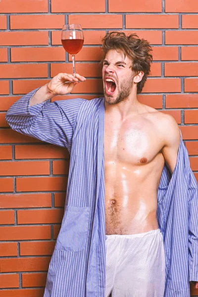 Drink wine and relax. Erotic and desire concept. Man sexy chest sweaty skin hold wineglass. Guy attractive relaxing with alcohol drink. Bachelor enjoy wine. Macho tousled hair degustate luxury wine