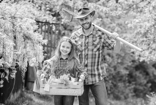 Planting season. Inspect your garden daily to spot insect trouble early. Family dad and daughter little girl planting plants. Day at farm. Popular in garden care. Planting flowers. Plant veggies — Stock Photo, Image