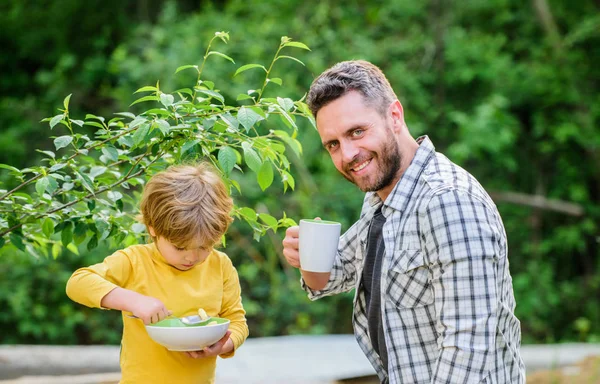Nutrition kids and adults. Healthy nutrition concept. Menu for children. Nutrition habits. Family enjoy homemade meal. Healthy breakfast. Father son eat food and have fun. Little boy and dad eating — Stock Photo, Image