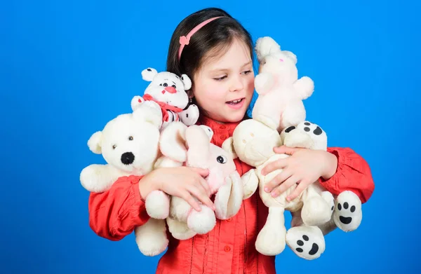 Small girl smiling face with toys. Happy childhood. Little girl play with soft toy teddy bear. Lot of toys in her hands. Childhood concept. Collecting toys hobby. Cherishing memories of childhood — Stock Photo, Image