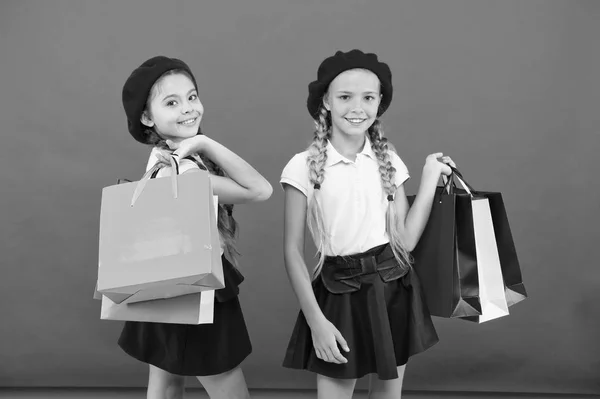 Great day for shopping. Children enjoy shopping red background. Visiting clothing mall. Discount and sale concept. Kids cute girls hold shopping bags. Shopping discount season. Special offer — Stock Photo, Image