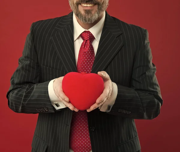 All my love is for you. diseased heart. Love and romance health care. mature man hold valentines heart. February holiday. Happy man with big red heart. businessman in suit. success and fortune