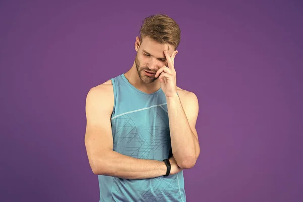What is on his mind. Man with strong muscular arms. Man muscular handsome unshaven thoughtful guy on violet background. Masculinity concept. Does having muscular body make you more confident
