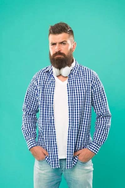 Wireless technology. Streaming sites hippest and hottest around. Free online music sources different features. Music chart. Hipster with beard listening music. Handsome music lover. Man in headphones