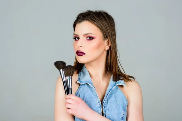 Op zoek naar goed en gevoel van vertrouwen. Make-up donkere lippen. Aantrekkelijke vrouw aanbrengen make-up borstel. Professionele make-up benodigdheden. Make-up artiest concept. Benadruk vrouwelijkheid. Meisje poeder ogen schaduwen toepassen — Stockfoto