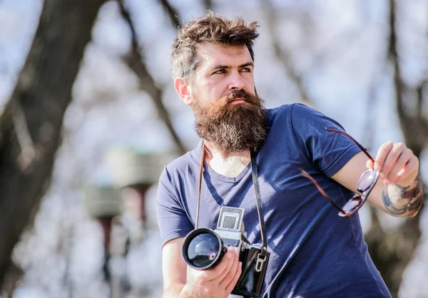 photographic equipment. hipster man in sunglasses. Mature hipster with beard. Bearded man. brutal photographer with camera. photo of nature. reporter or journalist. Successful journalist