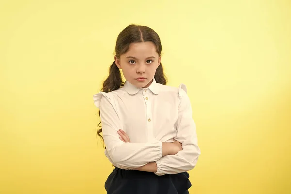 Confident schoolgirl. confident and carefree schoolgirl. small schoolgirl with confident look. confident schoolgirl on yellow background. — Stock Photo, Image