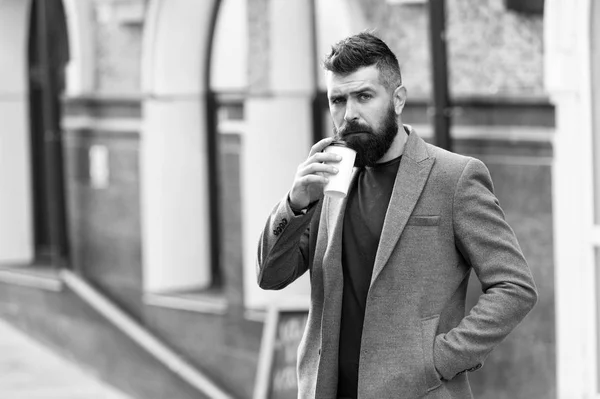 Businessman lumbersexual appearance enjoy coffee break out of business center. Relax and recharge. Man bearded hipster drinking coffee paper cup. One more sip of coffee. Drinking coffee on the go — Stock Photo, Image