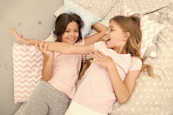 Slumber party concept. Girls just want to have fun. Invite friend for sleepover. Best friends forever. Consider theme slumber party. Slumber party timeless childhood tradition. Girls relaxing on bed