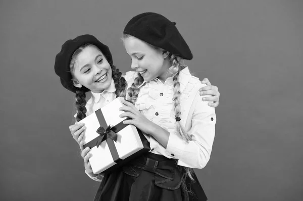 A friendship present. Little girl giving present to her friend. Happy children with small gift box wrapped with ribbon bow. Small kids enjoying holiday celebration. Birthday surprise. Happy birthday — Stock Photo, Image