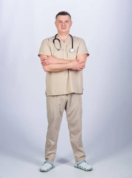 Private clinic. Check health. Doctor career. Man doctor with stethoscope physician uniform. Medicine and health care. Professional doctor. Experienced doctor beige clothes on white background