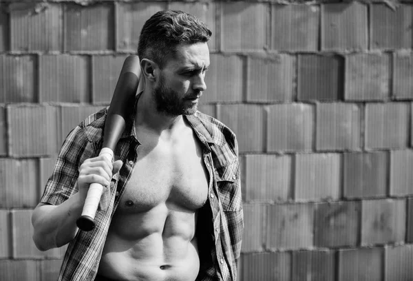 Strong temper. Principle concept. Confident his strength. Bully guy carry cudgel brick wall background. Power and strength. Feel my strength. Man unshaven face muscular torso hold black baseball bat — Stock Photo, Image
