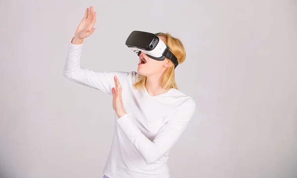 Woman using virtual reality headset. Woman wearing virtual reality goggles. Woman excited using 3d goggles. VR game.