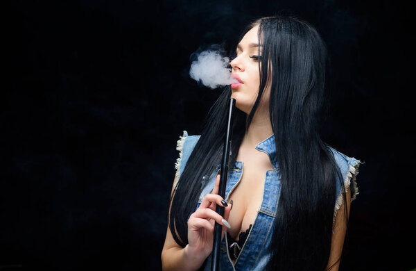 White cloud of smoke. Vaping is sexy. Nicotine addiction. Attractive busty brunette smoking vaping device. Girl vaping. Hookah bar. Electronic cigarette. Fashion girl vaping. Relaxing with hookah