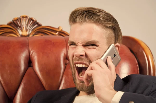 Angry boss. Man well groomed shout aggressively mobile phone grey background. Businessman angry call mobile phone. Mobile call connection. Guy handsome attractive office worker speak mobile phone