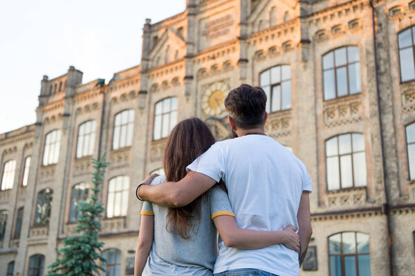 Happy together. Couple in love walking having fun. Tender hug. Love is a game that two can play and both can win. Couple relaxing enjoying each other. Hipster and pretty woman in love. Fall in love