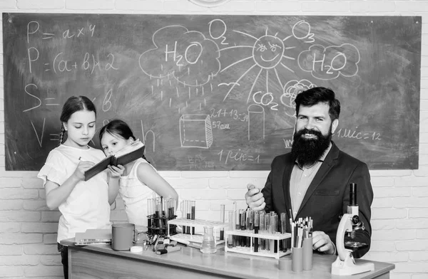 school kids scientist studying science. back to school. happy children teacher. Little kids learning chemistry in school laboratory. students doing science experiments with microscope in lab