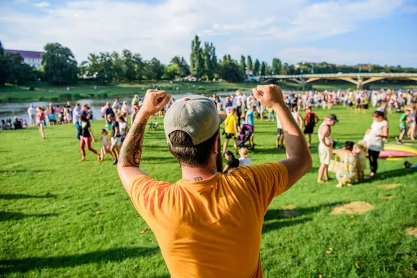 Being happy for someone. Happy fan. Happy hipster making winner gesture on summer landscape. Hipster gesturing with happy emotions in casual wear outdoor