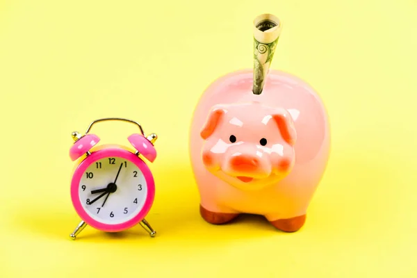 its time to get rich. retirement. family budget. business startup. financial position. piggy bank with alarm clock. Moneybox. usa dollar. Economy and budget increase. success in finance and commerce