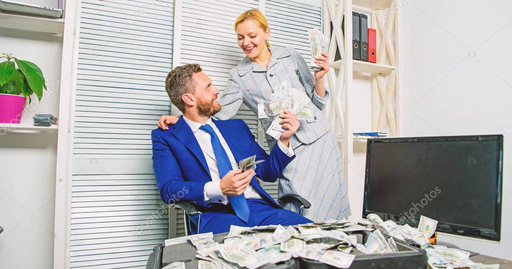 Man businessman and woman secretary with pile dollar banknotes. Profit and richness concept. Businessman near cash dollars profit. Huge profit concept. Financial success. Counting money profit