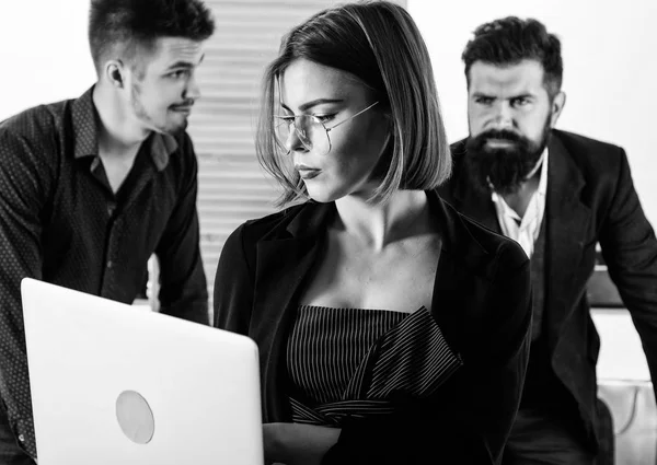 Confident and smart. Smart woman working on laptop computer with people in office. Smart female worker using modern technology for business. Sensual business lady wearing smart casual at work