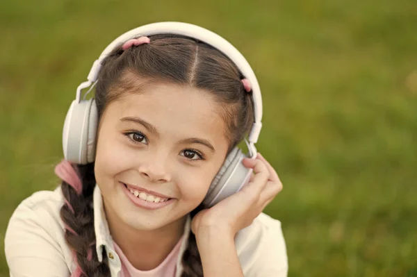 Listen to music. Beauty and fashion. small kid listen ebook, education. Childhood happiness. Mp3 player. childrens day. Audio technology. small girl child in headphones. Enjoying her favorite music