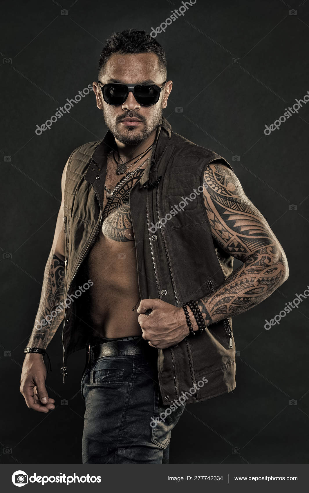 Tattoo model with beard on unshaven face. Tattooed man with six pack and ab. Bearded man Tattoo model with beard on unshaven face. Tattooed man with six pack and ab. Bearded man