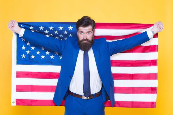 Give me liberty or give me death. Patriotic businessman celebrating american liberty on Independence day. Bearded man holding national flag symbol of pride and liberty. Personal liberty and free will