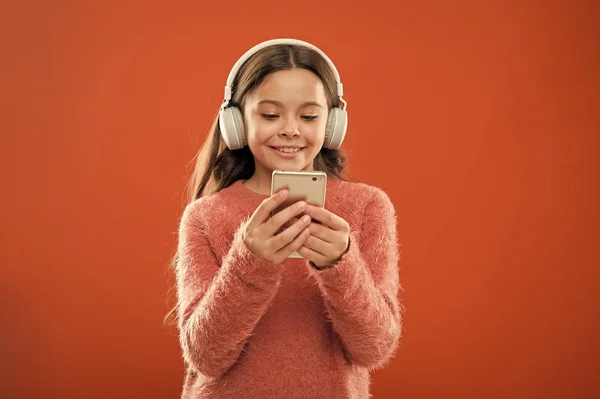 small kid listen ebook, education. small girl child in headphones. Childhood happiness. Mp3 player. Listen to music. Beauty and fashion. childrens day. Audio technology. Love this music