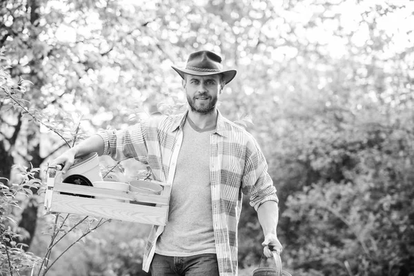 Sexy farmer hold wooden box with pot. farming and agriculture cultivation. Garden equipment. Eco farm worker. Harvest. happy earth day. Eco living. ranch man in cowboy hat. Confident gardener — Stock Photo, Image
