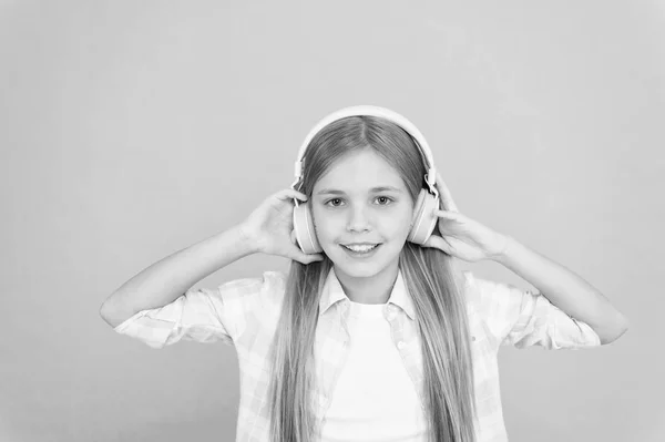 Eine ultrabequeme Passform für sie. liebenswerter Musikfan. kleines Mädchen, das Musik hört. fröhliches kleines Kind genießt die Musik, die mit Kopfhörern gespielt wird. Musik macht sie glücklich — Stockfoto