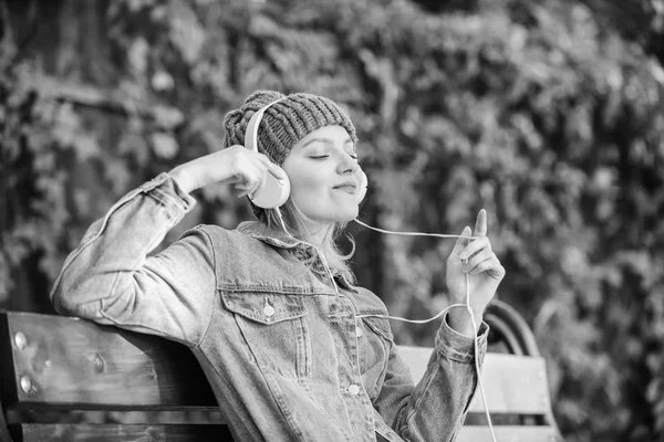 Feeling awesome. Cool funky girl enjoy music in headphones outdoor. Girl listen music in park. Melody sound and mp3. Music fan concept. Headphones must have modern gadget. Enjoy powerful sound — Stock Photo, Image