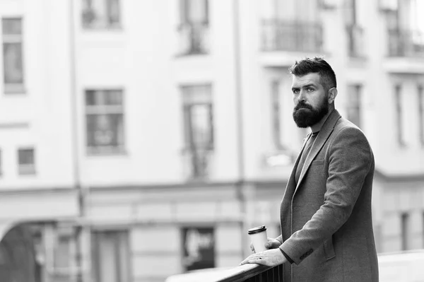 Man bearded hipster drinking coffee paper cup. One more sip of coffee. Enjoying coffee on the go. Businessman well groomed appearance enjoy coffee break out of business center. Relax and recharge — Stock Photo, Image