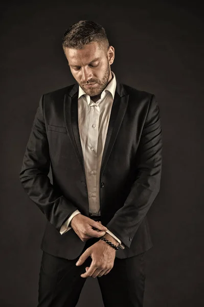 Man in formal outfit on black background