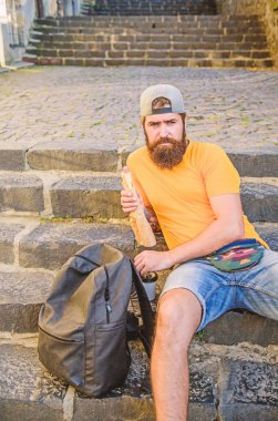 Biraz dinlenmek ve daha fazla yürüyüş. Kafkas hipster yürüyüş sırt çantası ile merdivenlerde rahatlatıcı. Sakallı adam yemek molası veriyor. Yaz tatili ve yürüyüş sezonu