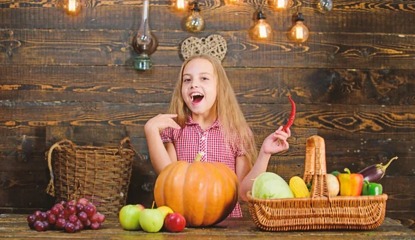 Farm themed games and activities for kids. Girl kid at farm market with fall harvest. Child little girl celebrate harvesting. Kid farmer with harvest wooden background. Family farm festival concept