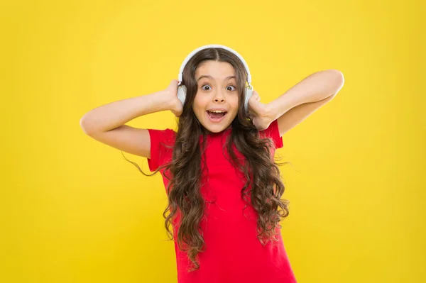 Give in to the groove. Little DJ on yellow background. Cute girl listening to music in DJ headphones. Small child using wireless headset for DJ disco. Adorable kid enjoying DJ tune playing in radio — Stock Photo, Image