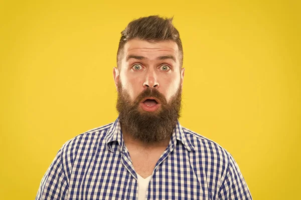 Guy surprised face expression. Hipster with beard and mustache emotional surprised expression. Rustic surprised macho. Surprising news. Man bearded hipster wondering face yellow background close up