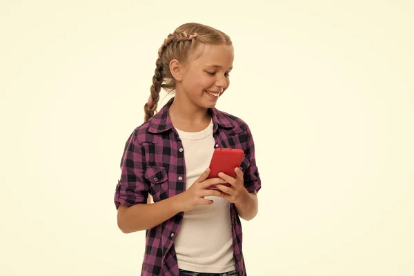 Examining her brand phone gadget. Mobile phone dependence. Girl cute small child smiling to phone screen. Internet surfing and social networks. Mobile phone and internet addiction or obsession