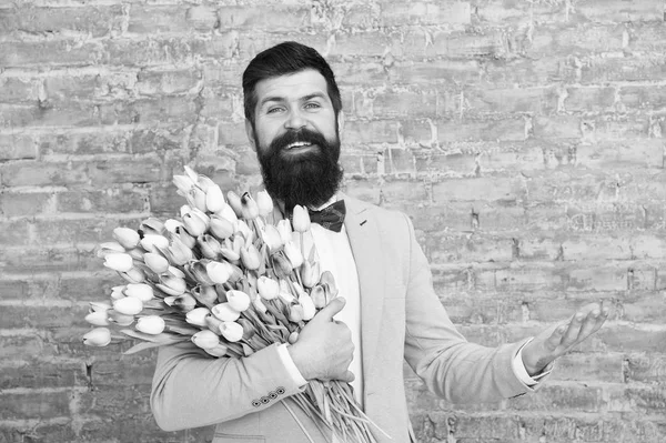 Spring everywhere. Womens day. Flower for March 8. Spring gift. Bearded man hipster love flowers. Bearded man with tulip bouquet. Love date. international holiday. Love spring. Love is in the air — Stock Photo, Image