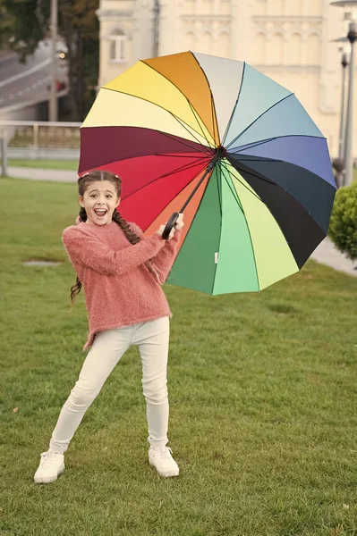 Girl child long hair walking park with umbrella. Stay positive and optimistic. Colorful accessory positive influence. Bright umbrella. Under big umbrella. Colorful accessory for cheerful mood — Stock Photo, Image