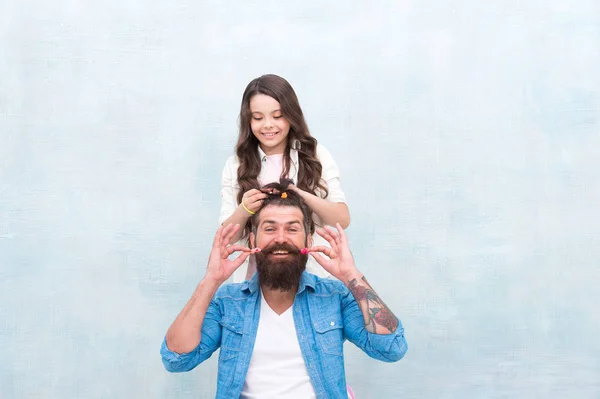 Change hairstyle. Raising girl. Create funny hairstyle. Child making hairstyle styling father beard. Being parent means present for kid interests. Daughter hairstylist. Enjoy fatherhood. Happy moment
