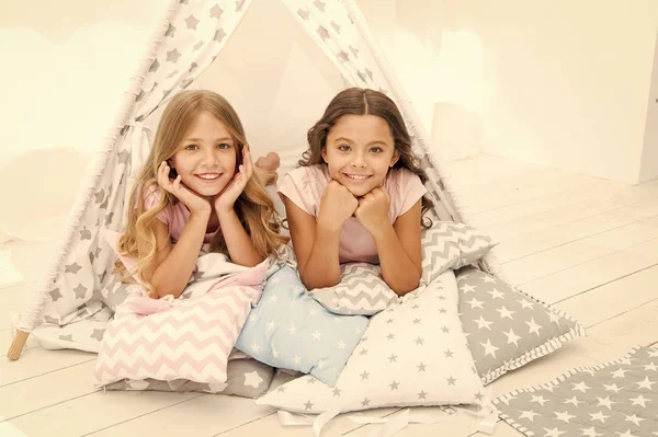 Girlish leisure. Sisters friends share gossips having fun at home. Pajamas party for kids. Siblings best friends. Sisters or best friends spend time together in bedroom. Girls having fun together