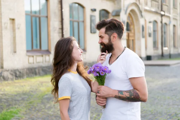 True feelings. Pick up girl for date. Bearded hipster fall in love. Couple meeting for date. Bouquet gift. Man giving flower bouquet. Romantic date. Guy prepared surprise bouquet for girlfriend