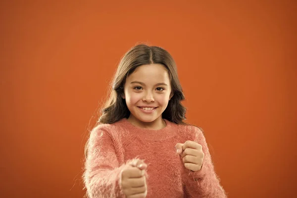 Self defense for kids. Defend Innocence. How teach kids to defend themselves. Self defense strategies kids can use against bullies. Girl hold fists ready attack or defend. Girl child cute but strong