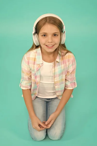 Listen to music. Beauty and fashion. small kid listen ebook, education. Childhood happiness. Mp3 player. childrens day. Audio technology. small girl child in headphones. Enjoying music