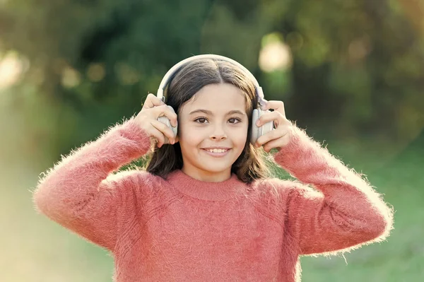 Reasons you should use headphones. Headphones changed world. Headphones bring privacy to public spaces. Active lifestyle music play list. Music always with me. Girl cute child with headphones — Stock Photo, Image